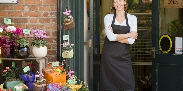 Woman Working At Flower Shop Smiling