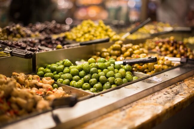 Olives on sale/display in a food market/grocery store specialty grocery pos