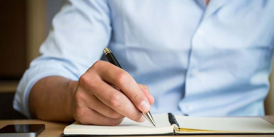 businessman writing restaurant business plan