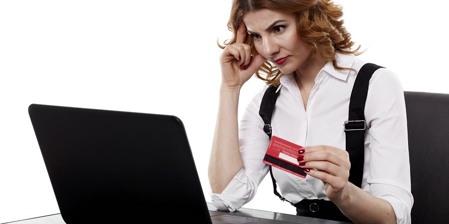 Suspicious Businesswoman With Credit Card business woman trying to decide where to buy her POS system from