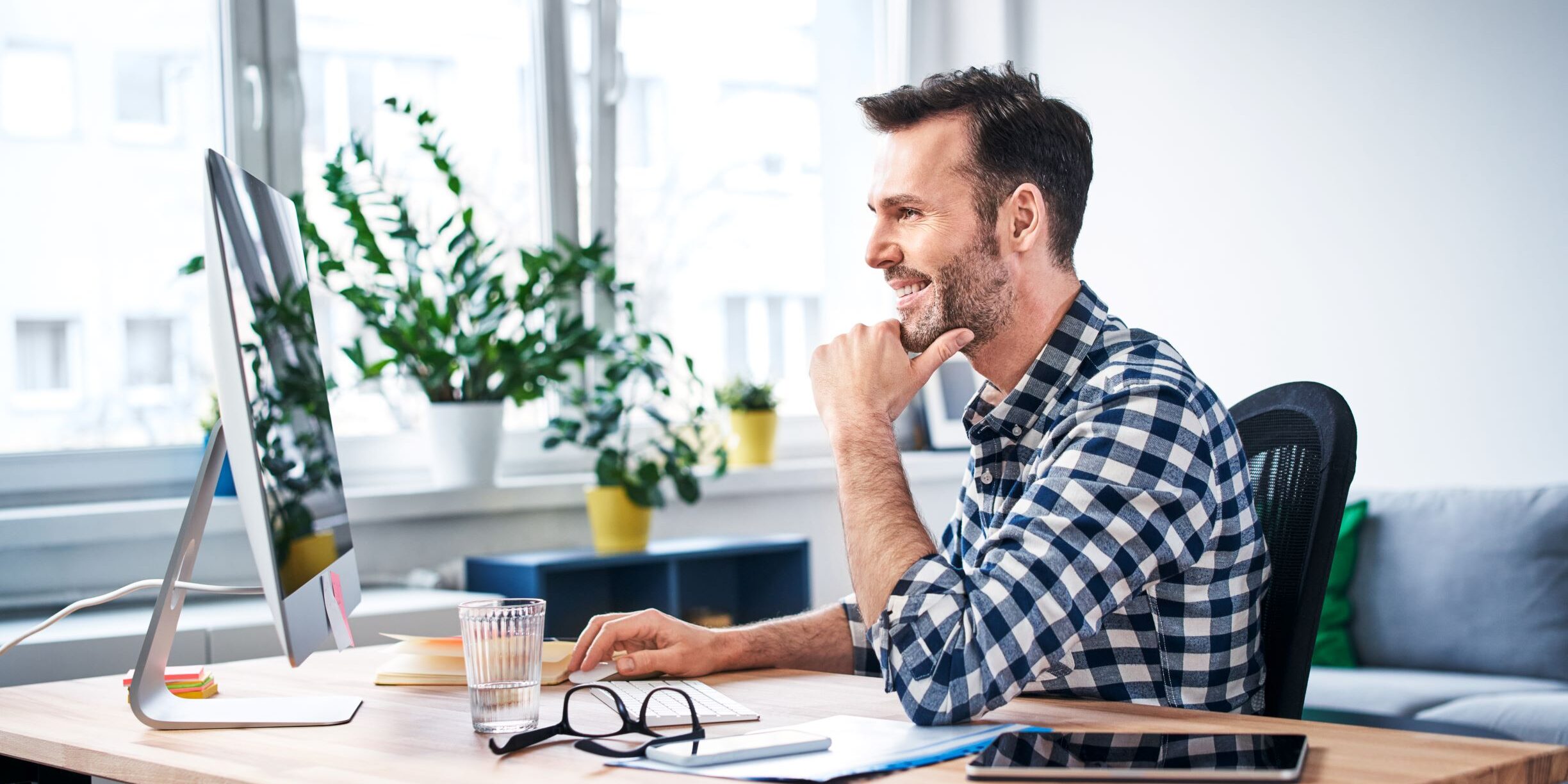 man-on-computer-in-office man managing business from office