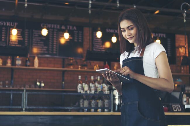 cafe manager using tablet for restaurant management system