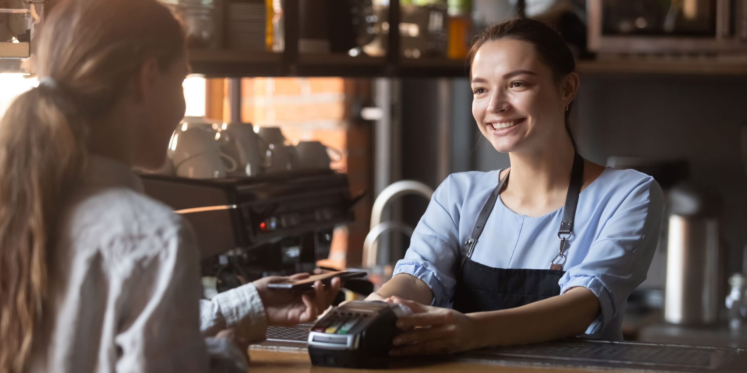 woman paying with mobile restaurant payment technology