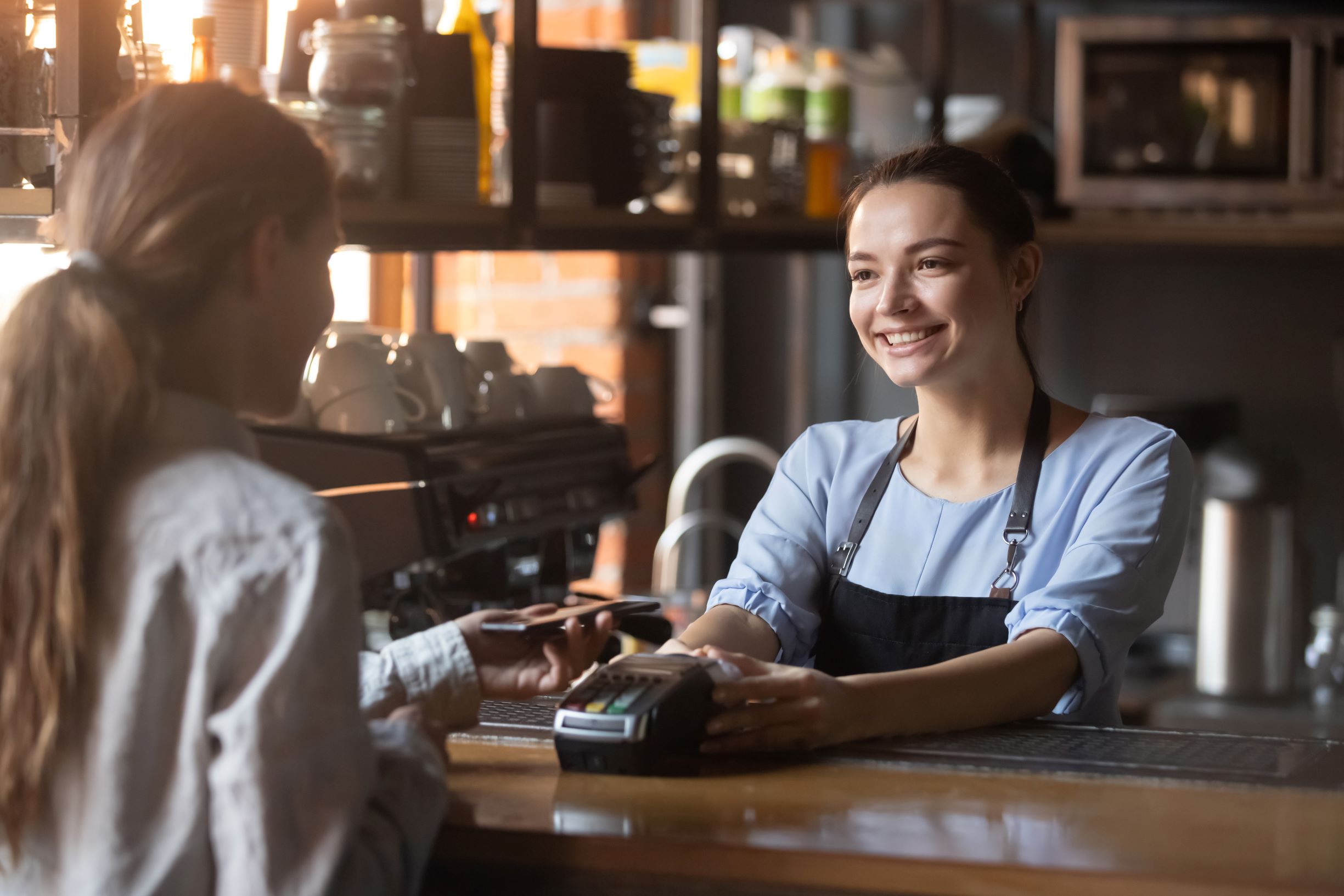 woman paying with mobile restaurant payment technology