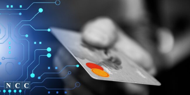 credit card in hand with technology lines