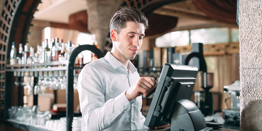 small business, people and service concept – happy man or waiter How To Use a Point of Sale System | NCC