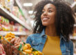 Excited person browsing a grocery aisle, shelves packed with vib